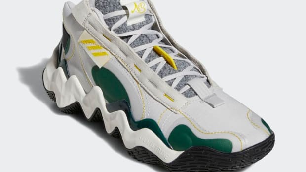 View of white and green adidas basketball shoes.